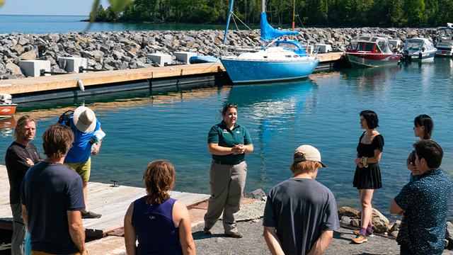 Staff giving a presentation to visitors at a marina.
