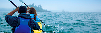 Two people in a tandem kayak.