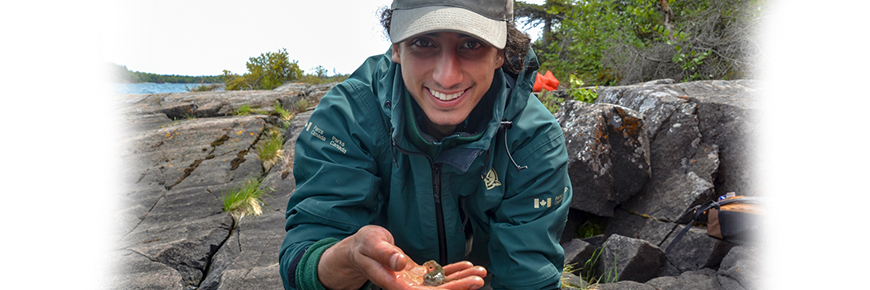 A Parks Canada staff shows a sculpin found in the shallows of Lake Superior.
