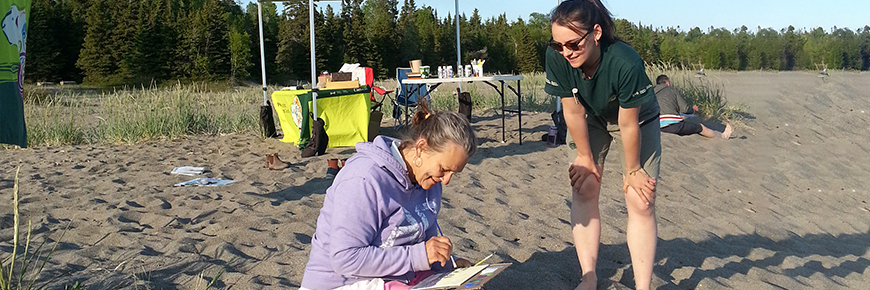 Parks Canada staff share techniques of artists inspired by Lake Superior on Terrace Bay beach (photo taken prior to the pandemic).