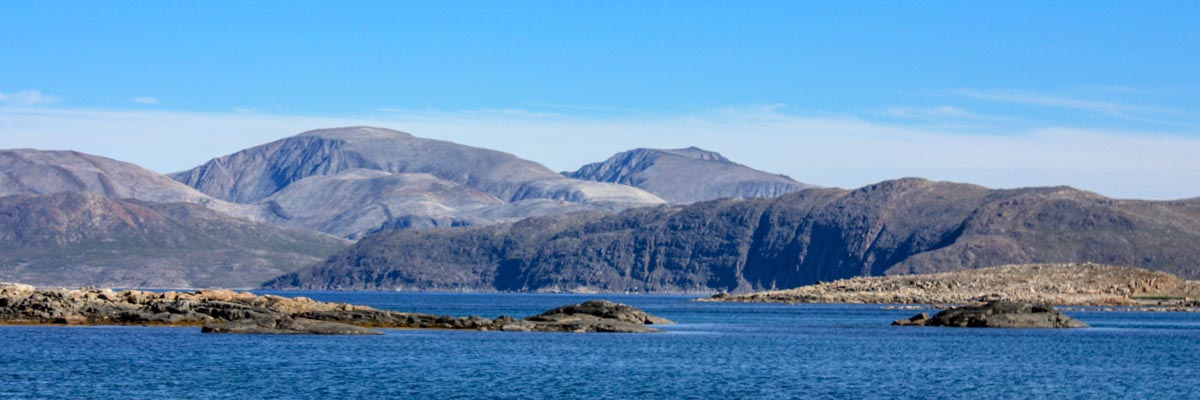 Panoramic landscape of far-off hills and cliffs in Torngat Mountains National Park. 