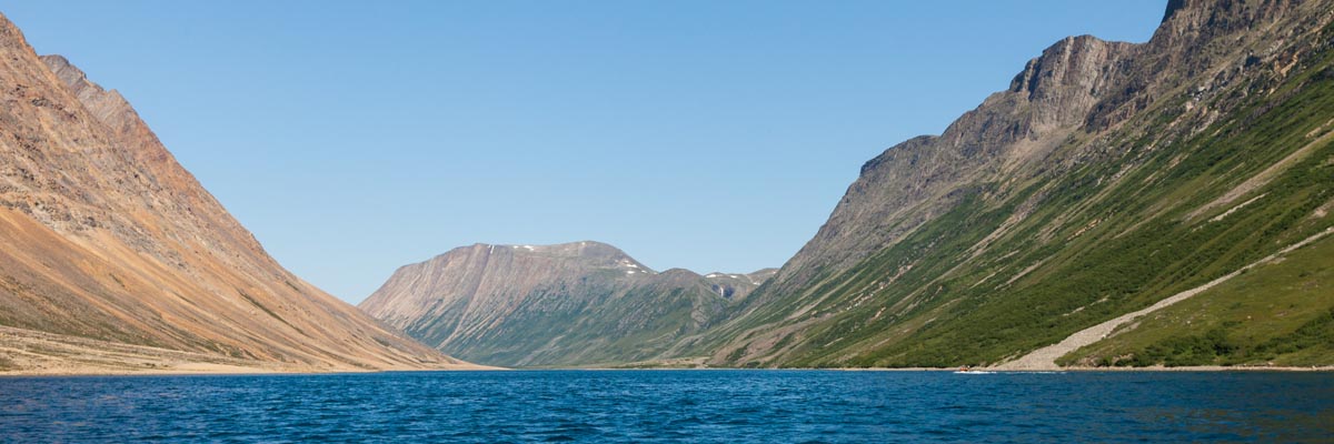Cliffs and mountains line a river in Torngat Mountains National Park. 