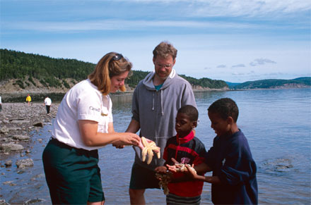 Interpreter with children on beach