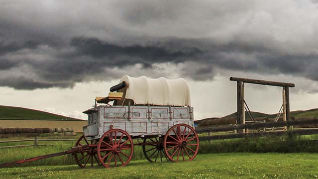 Covered wagon and wooden fencing