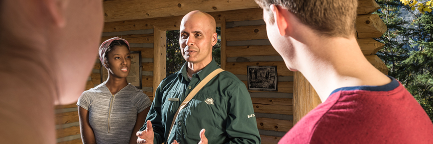 Parks Canada staff, speaking to visitors at cave and basin