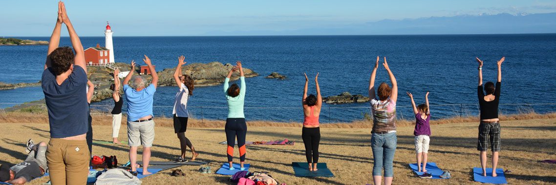 A group of people are doing yoga on the top of Lower Battery.