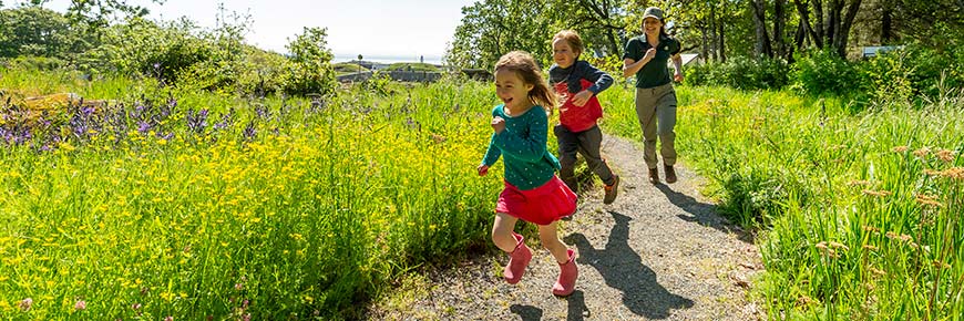 Children run through the Gary Oak learning meadow. 