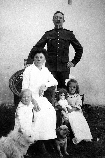 A family portrait of parents with two young children, circa 1916.