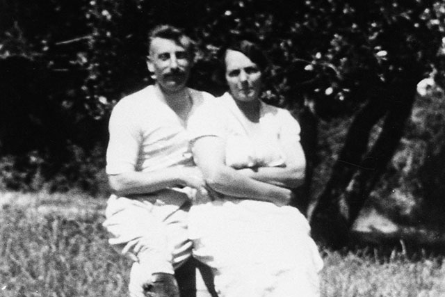 A couple sitting together on a rock, circa 1927.