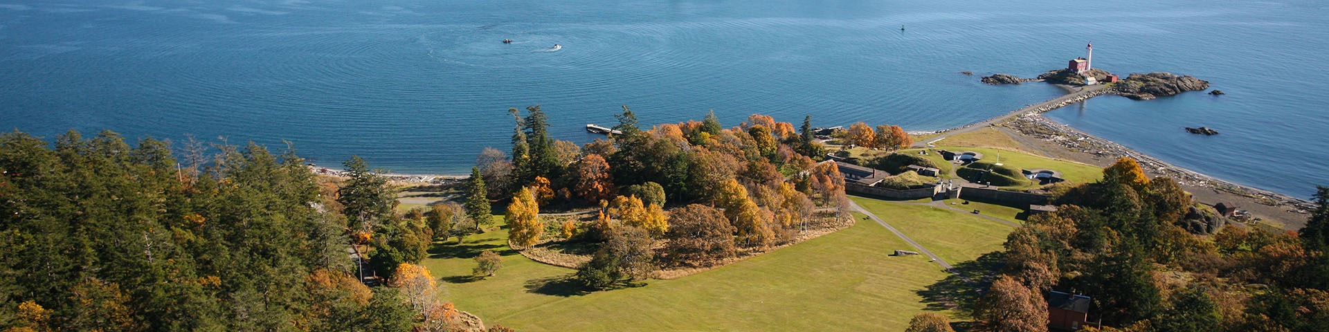 Aerial shot of Fisgard Lighthouse and Fort Rodd Hill with the ocean in background.