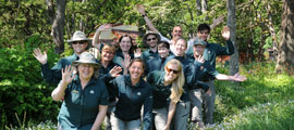 A group of Parks Canada staff waving in a field.