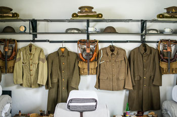 Exhibit display in Casemate Barracks, showcasing uniform pieces hung up on the wall.