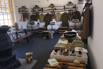 A display inside the soldiers’ sleeping quarters, showing uniforms and personal items.