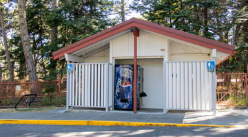 Picture of the washroom building by the main entrance and parking area.