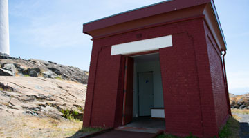 Picture of the historic storehouse and water tank building, which has been converted into an accessible and gender-inclusive washroom.