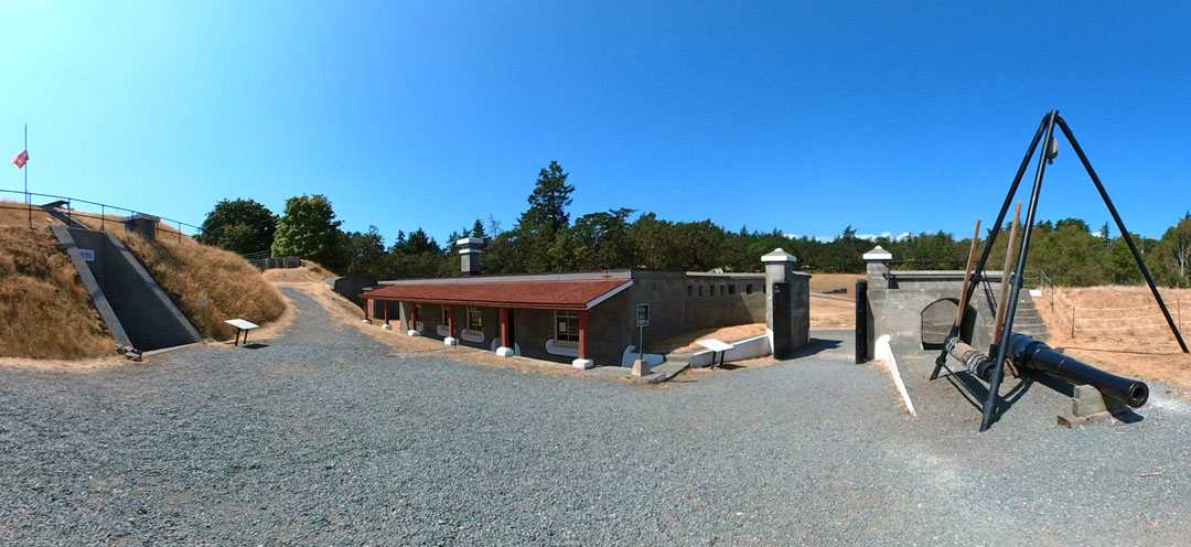 A panoramic view of Lower Battery area with its guardhouse, magazine, and Gin triangle with resting 6-inch gun barrel.