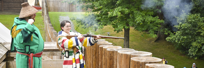 People fire historic weapons at Fort Langley National Historic Site