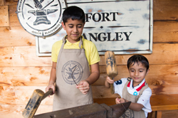 Children hammering an anvil