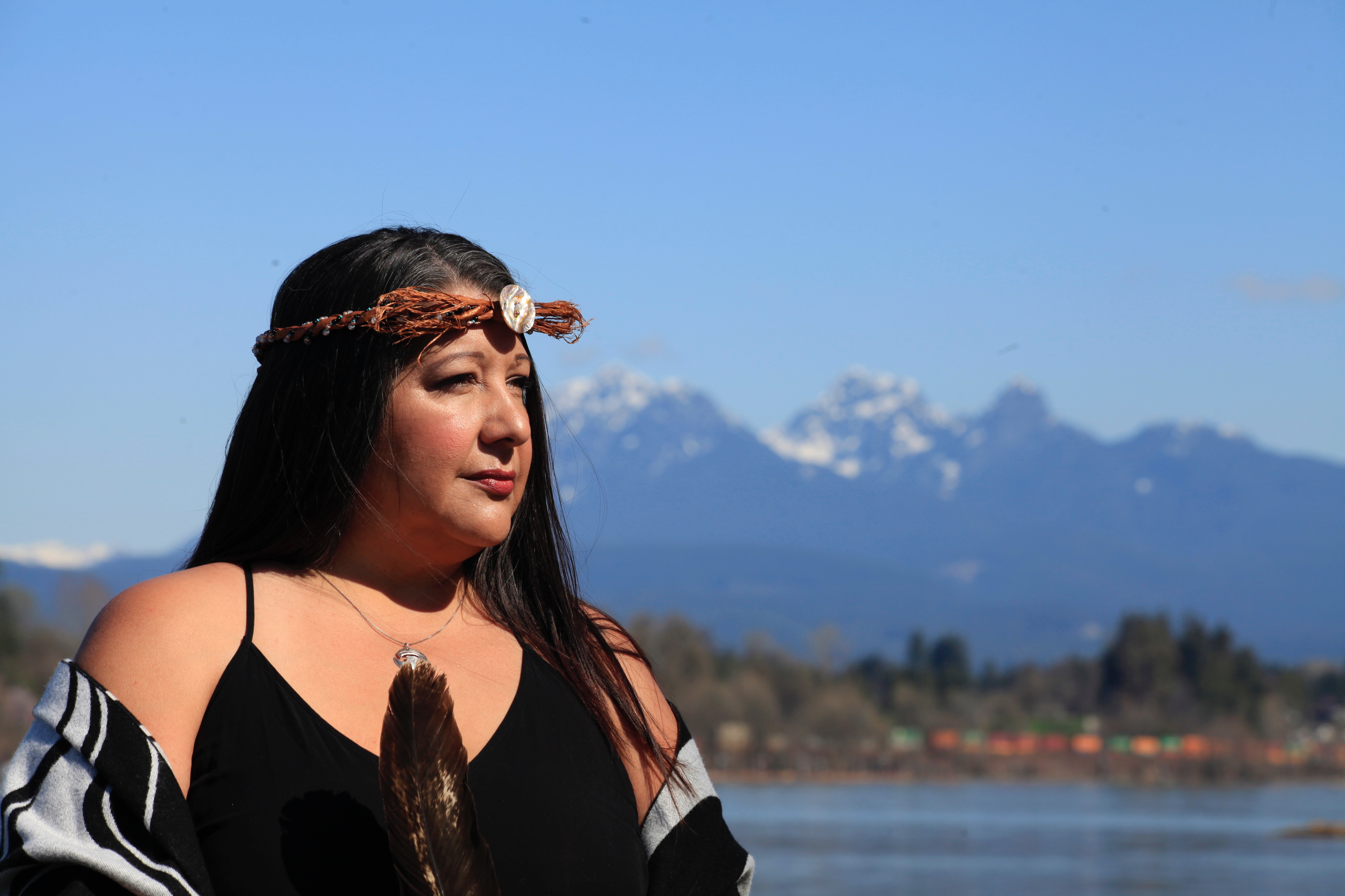 Outdoor portrait of Deanna Miller in front of a river and mountain range.