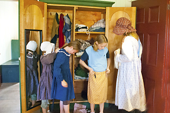 Girls trying on costumes in the Big House