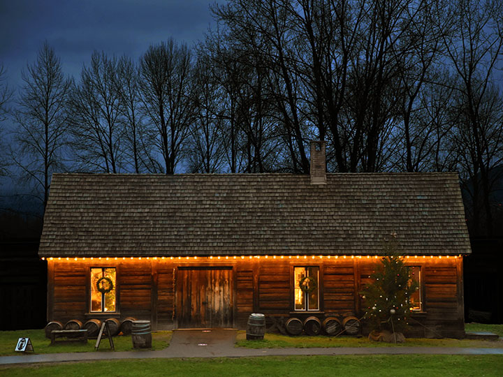 Night shot of the Cooperage building decorated with white string lights.