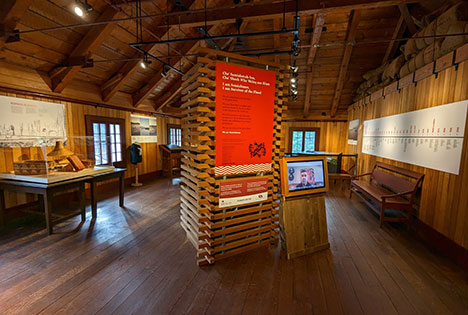 The exhibit layout, showing displays cases, touch screens and posters