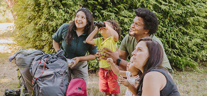 Parks Canada staff show a family about bird watching