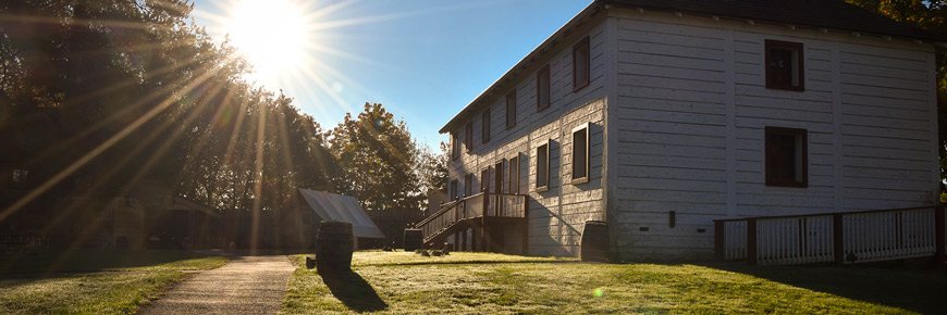 Sun shining behind Fort Langley’s Big House