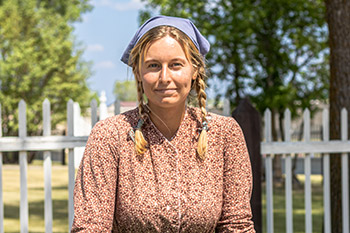 A woman in a historical costume at Lower Fort Garry.