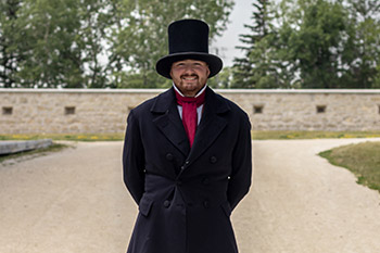 A man in a historical costume at Lower Fort Garry.