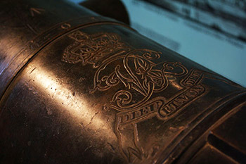 Close up of the crest visible on the top of the cannon. Crest includes a crown and a banner below reading Dieu et mon Droit.