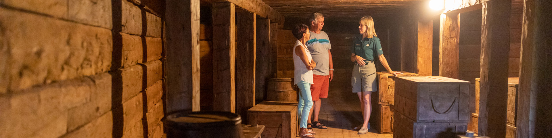 A Parks Canada interpreter gives a tour to visitors inside a casemate.