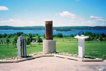Triptych located at the orientation area at Saint Croix Island International Historic Site. Saint Croix Island is in the background.