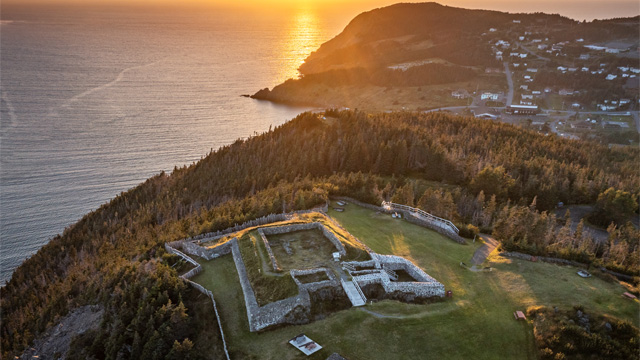 Aerial view of a star fort overlooking a coastal sunset