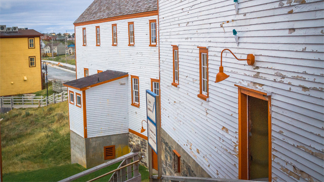 close-up of two white buildings with orange trim