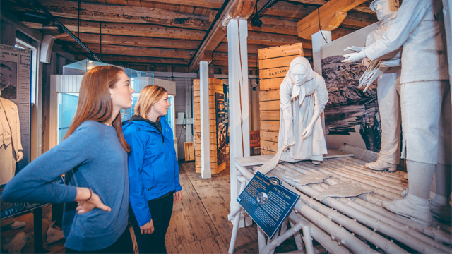 two individuals looking at some stone statues