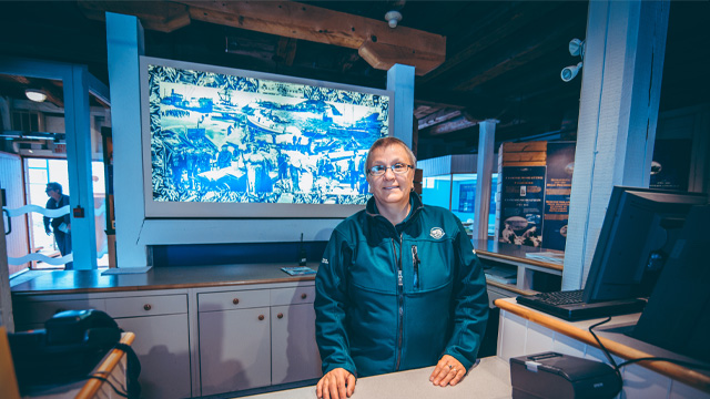 a Parks Canada employee standing at a desk