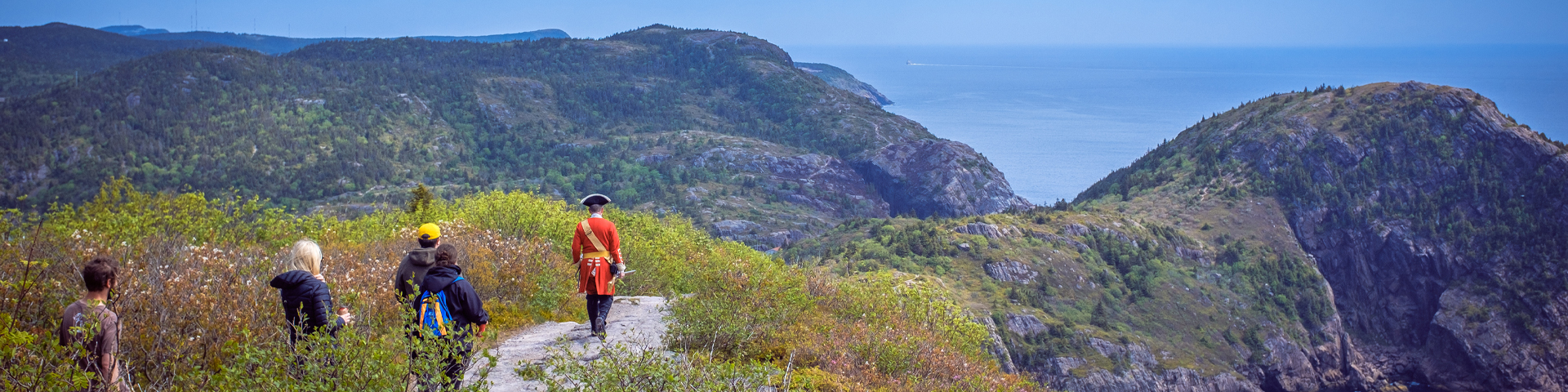 people walking along a coastal path