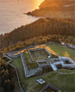 Aerial view of a star fort overlooking a coastal sunset