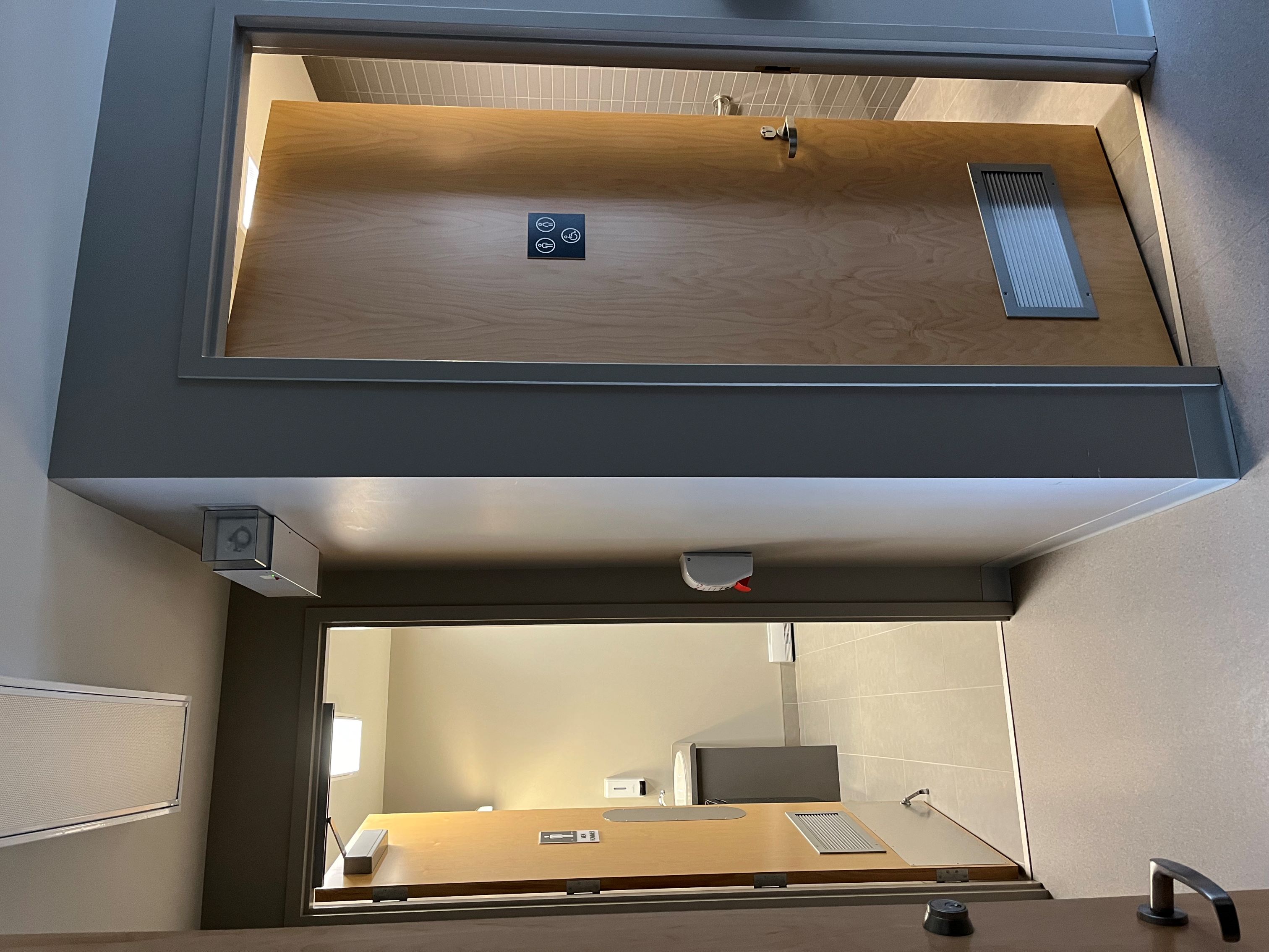 Two washrooms with their doors opened.