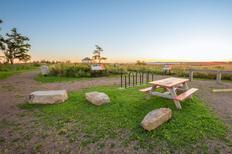 A picnic table, trails and a view park in a vast open area.