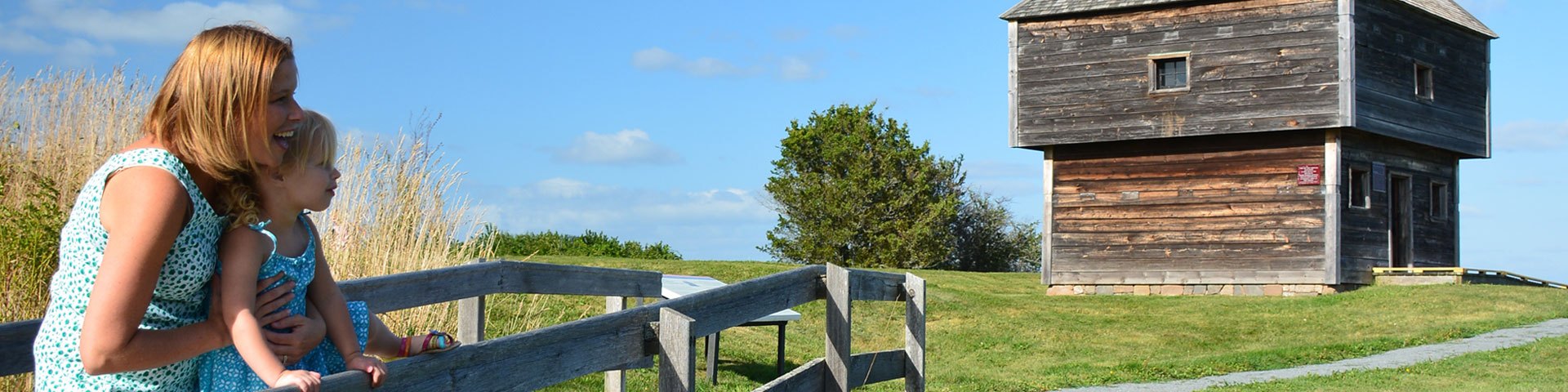 A mother and child looking at the blockhouse. 