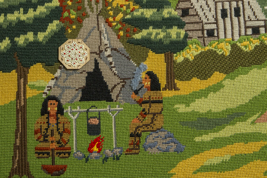 Two people cooking over a fire in front of a wigwam, the Habitation in the background.