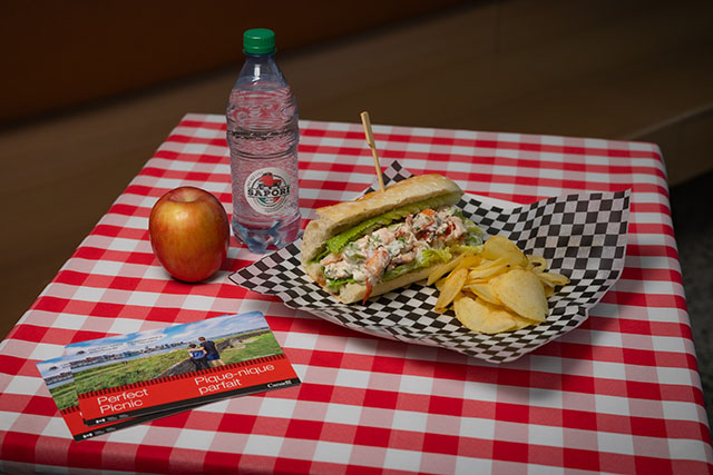 Lobster roll, water, apple and chips.