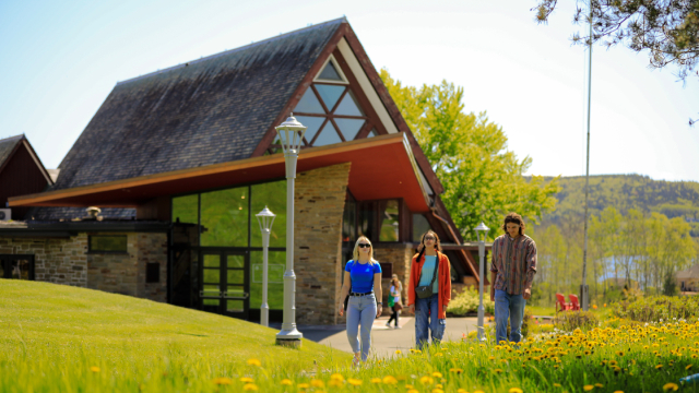 Three people walking side by side away from the museum after visiting
