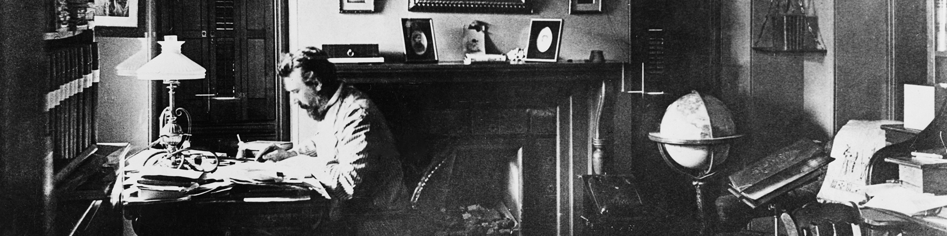 Alexander Graham Bell working at his home desk in Washington, DC in 1884. 