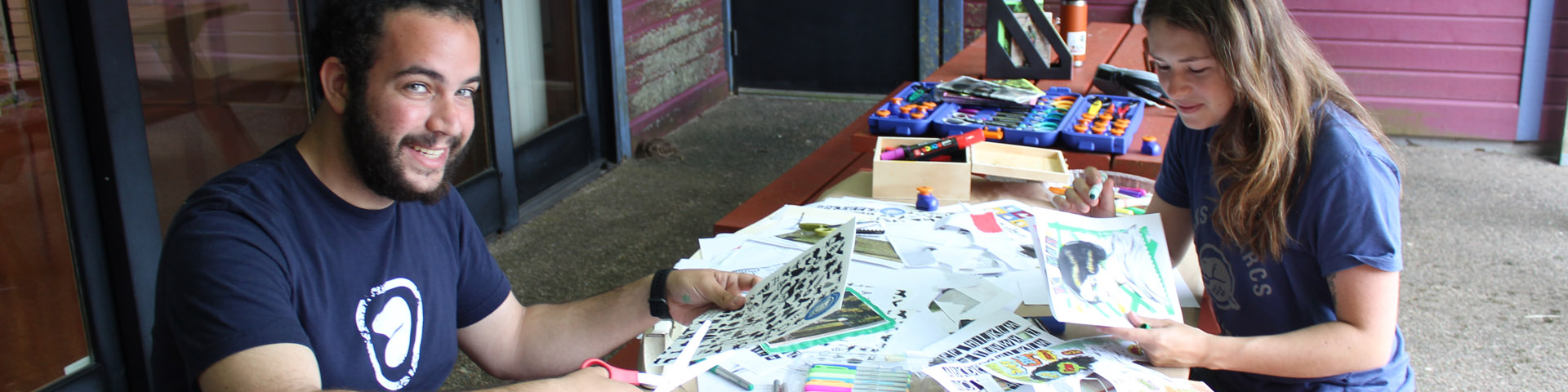 Visitors create artwork using newspaper clippings at Grand-Pré National Historic Site.