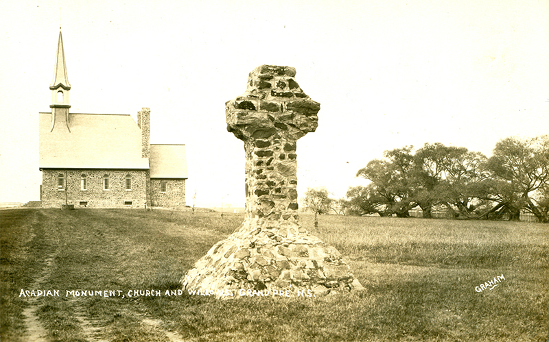 Historic photo of the Herbin Cross monument with the Memorial Church in the background