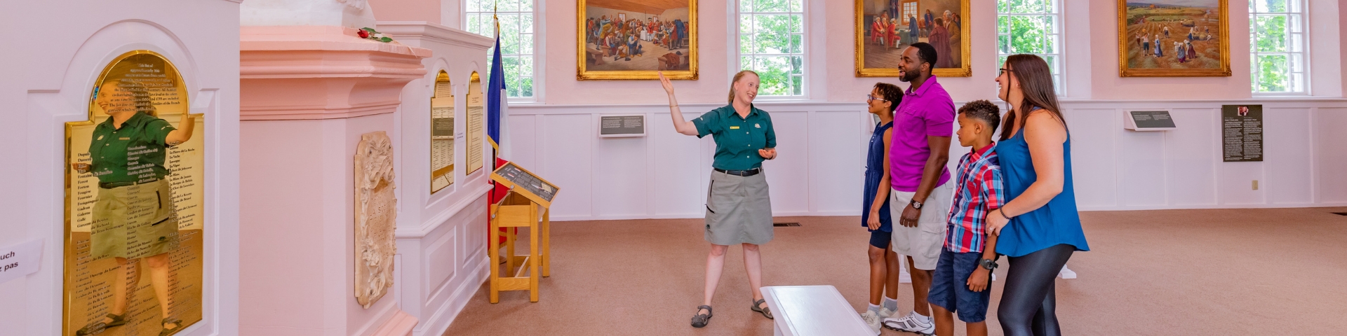 A Parks Canada interpreter with visitors inside the Memorial Church