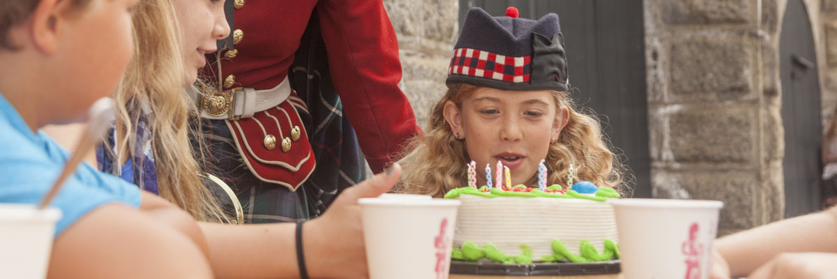 A child with a birthday cake.